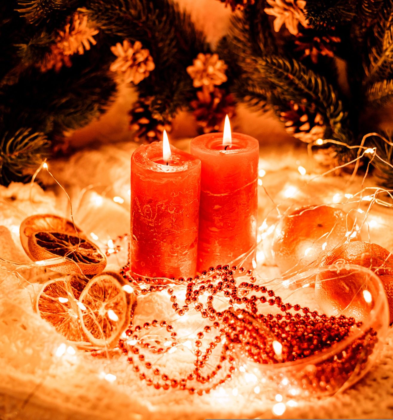 Red candles with festive decorations and lights.